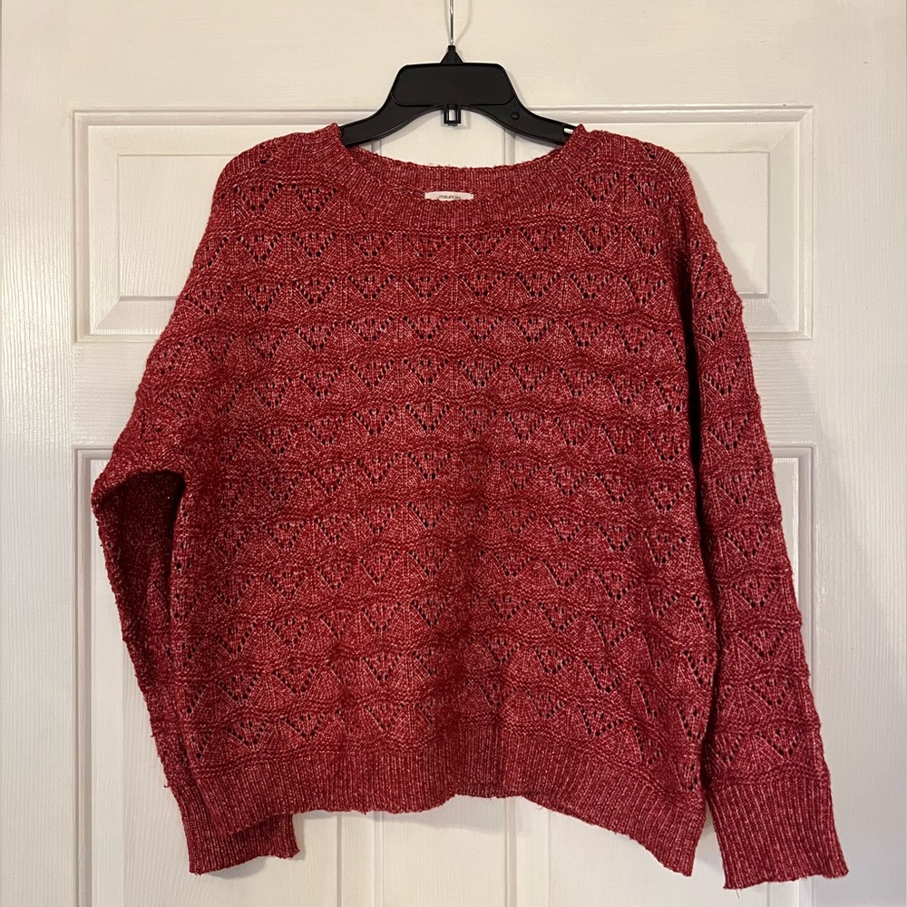 Red loose weave sweater.